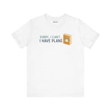 White premium soft tee with 'Sorry, I Can't - I Have Plans' design featuring a book and camping elements.