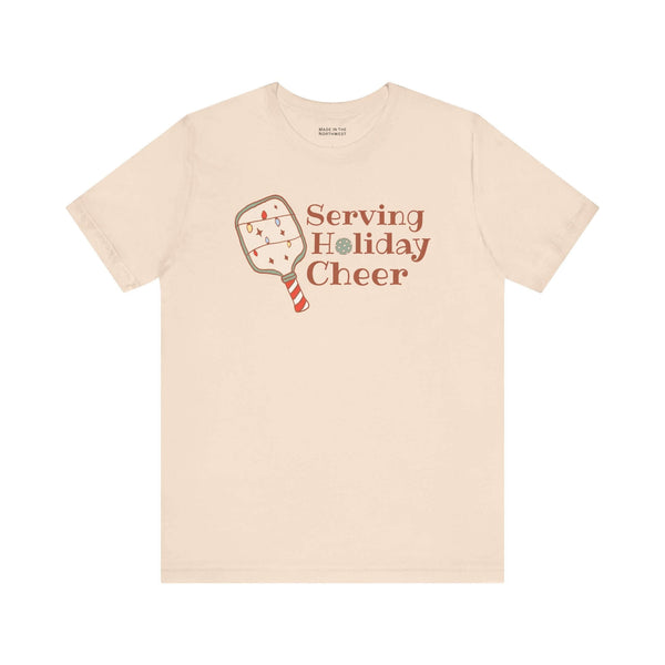 Serving Holiday Cheer Pickleball T Shirt featuring a festive paddle design with Christmas lights.