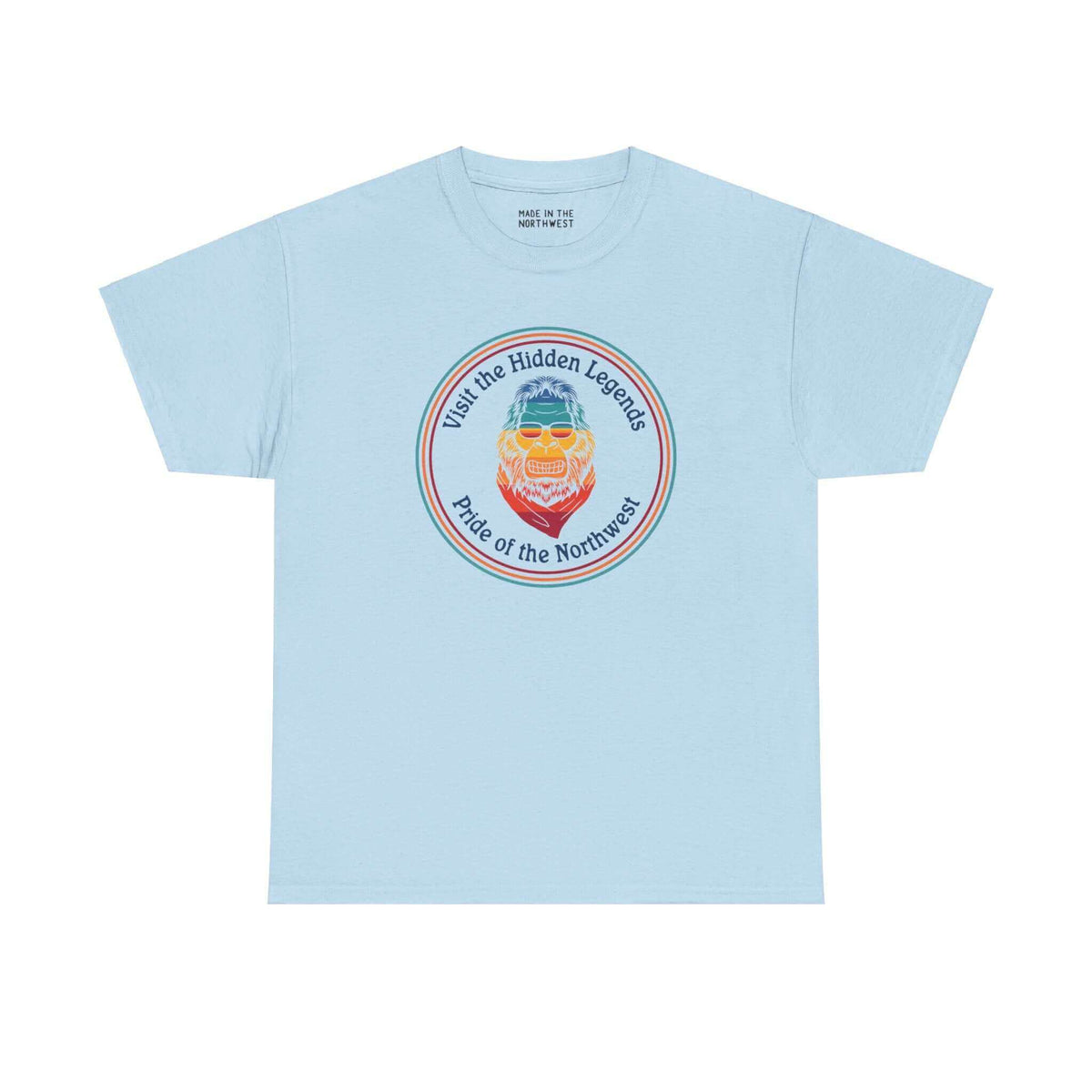 Light blue tee featuring vibrant Bigfoot graphic and "Visit the Hidden Legends, Pride of the Northwest" text, celebrating Pacific Northwest spirit.