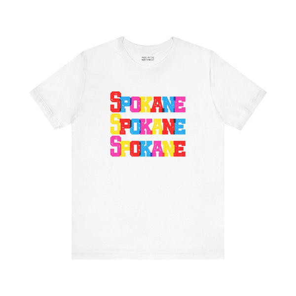 Bold Spokane soft tee with colorful block-letter design, perfect for fans of Lilac City, available in multiple colors.