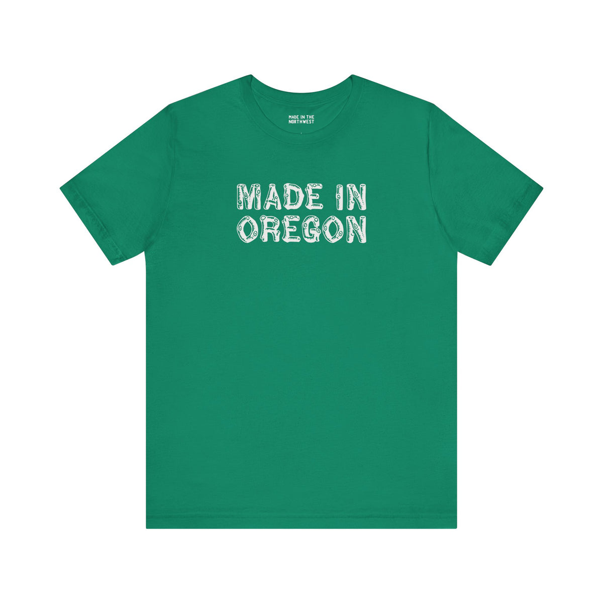 Green tee featuring rustic 'Made in Oregon' log font, perfect for outdoor lovers and Pacific Northwest pride.