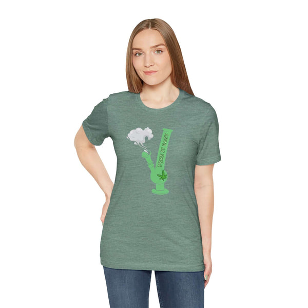 Woman wearing Toke It Easy cannabis lovers premium soft tee with bold green bong graphic and marijuana leaf.