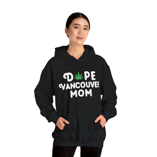 Woman wearing "Dope Vancouver Mom" hoodie with a playful marijuana leaf design, celebrating unique style and local pride.