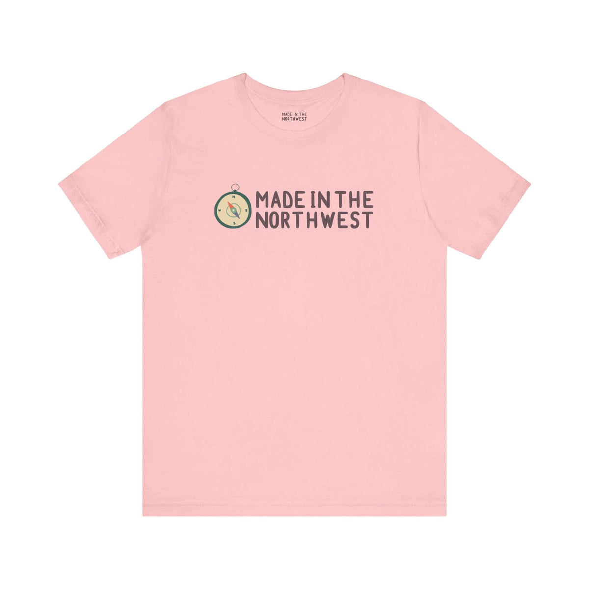 Pink tee with 'Made in the Northwest' logo and compass design, showcasing Pacific Northwest pride. Perfect for adventurers and explorers.