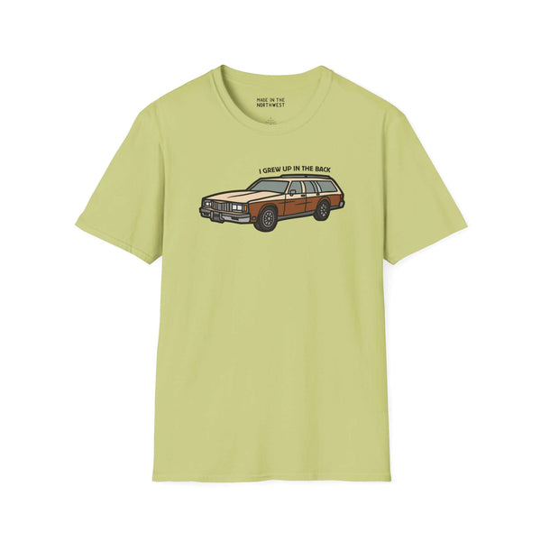 I Grew Up in the Back softstyle t-shirt featuring an Oldsmobile Custom Cruiser design in light green.