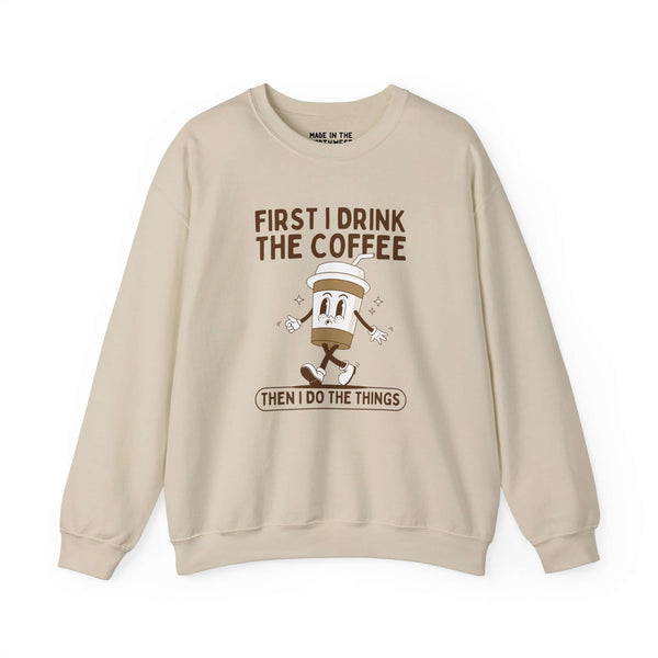 Light beige sweatshirt with the phrase 'First I Drink the Coffee Then I Do the Things' and a coffee cup graphic.