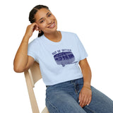 Model wearing Out of Office Camper Softstyle T-Shirt featuring retro travel trailer design for road trip lovers.