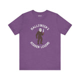 Halloween's Hidden Legend Bigfoot tee in purple, featuring Bigfoot in a Jason mask with a knife.