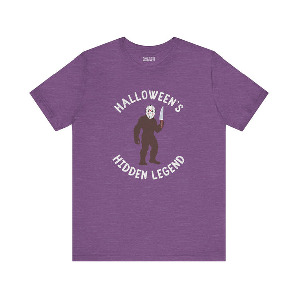Halloween's Hidden Legend Bigfoot tee in purple, featuring Bigfoot in a Jason mask with a knife.
