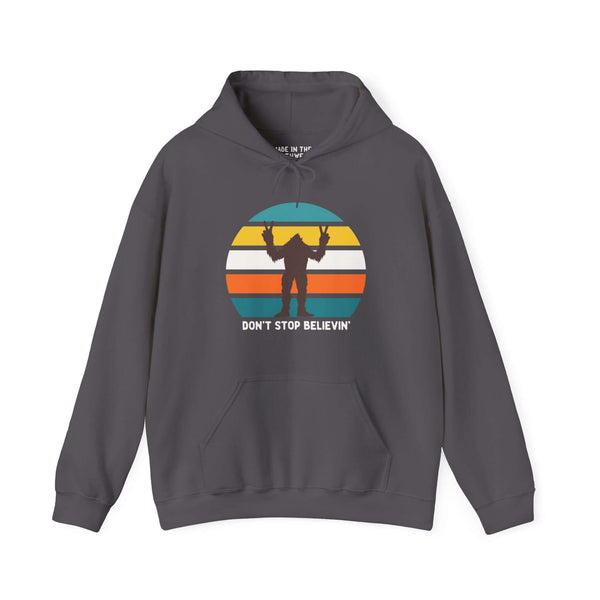 Bigfoot hoodie with "Don't Stop Believin'" graphic in front of a retro sunset design.