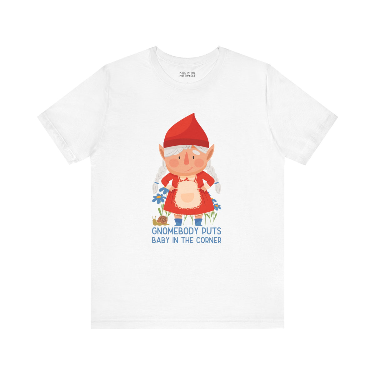 Premium white tee featuring a whimsical female gnome with the text 'Gnomebody Puts Baby in the Corner'