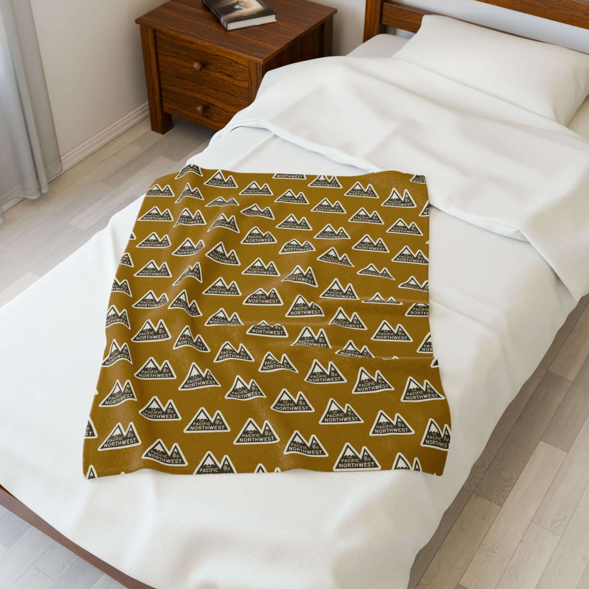 Pacific Northwest Heights Mountain Lightweight Cozy Blanket displayed on a bed, showcasing a bold mountain design.