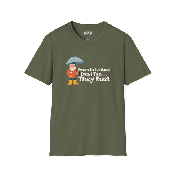 Green t-shirt featuring 'People in Portland Don't Tan, They Rust' design with character under an umbrella.