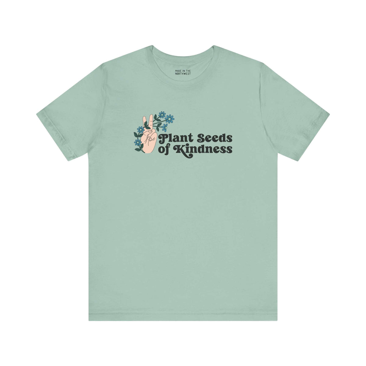 Mint green tee with 'Plant Seeds of Kindness' text and a hand peace sign surrounded by flowers.