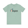 Mint green tee with 'Plant Seeds of Kindness' text and a hand peace sign surrounded by flowers.