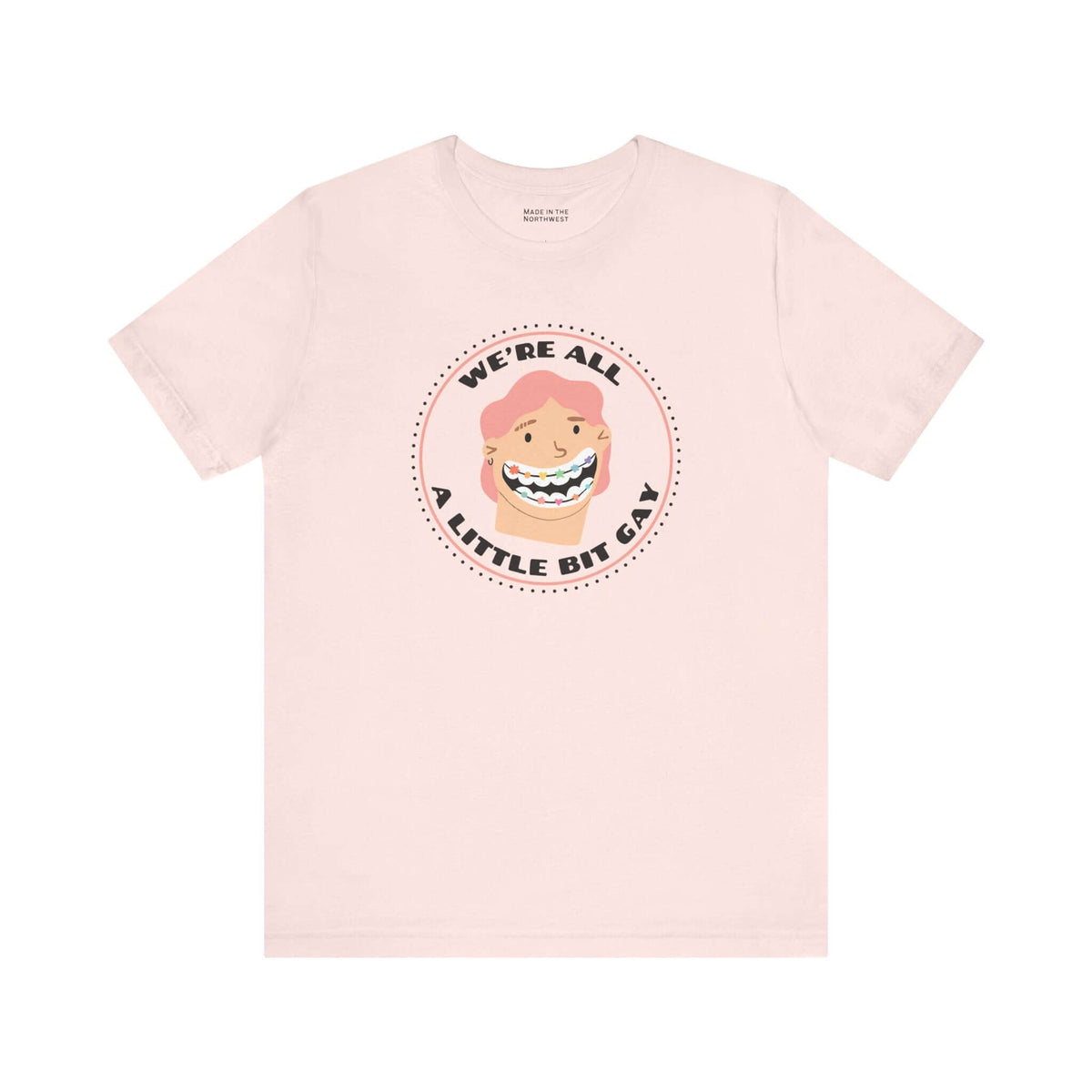 We're All a Little Bit Gay Tee featuring playful design and bold lettering on a soft pink shirt.