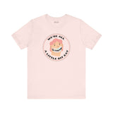 We're All a Little Bit Gay Tee featuring playful design and bold lettering on a soft pink shirt.