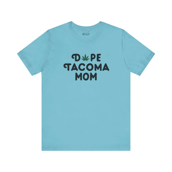 Light blue tee with "Dope Tacoma Mom" text, featuring a marijuana leaf as the "O" in "Dope" – perfect for stylish Tacoma moms.