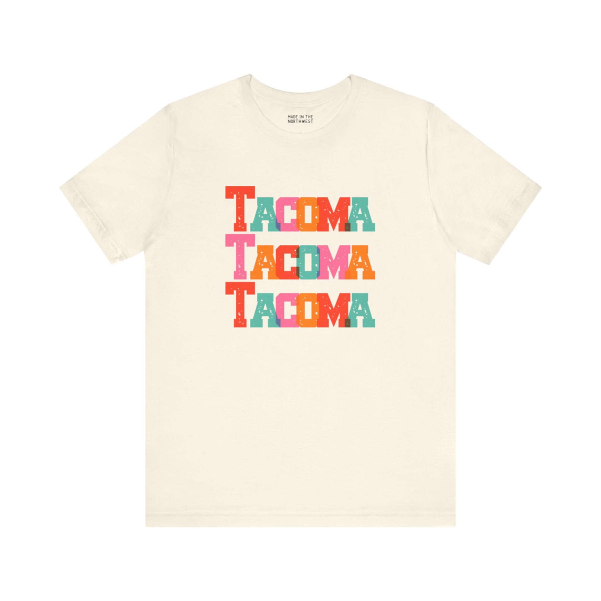 Bold and bright Tacoma Trio Soft Tee featuring colorful block letters stacked on a cream shirt, perfect for Tacoma fans.