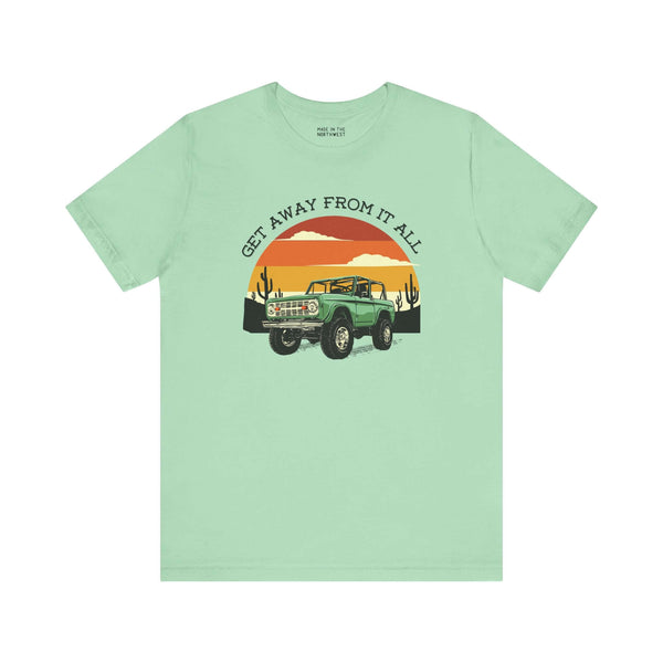 Mint green soft tee featuring a vintage Bronco design and sunset graphics for adventure lovers.