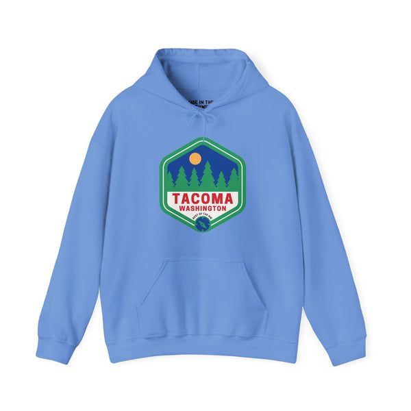 Blue Tacoma hoodie with 90s retro badge featuring trees and sun, showcasing Grit City pride and Northwest outdoors.