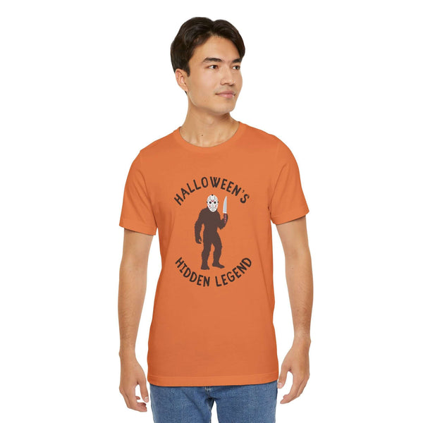 Halloween's Hidden Legend Bigfoot tee featuring a Sasquatch in a Jason mask with a knife, ideal for spooky season.