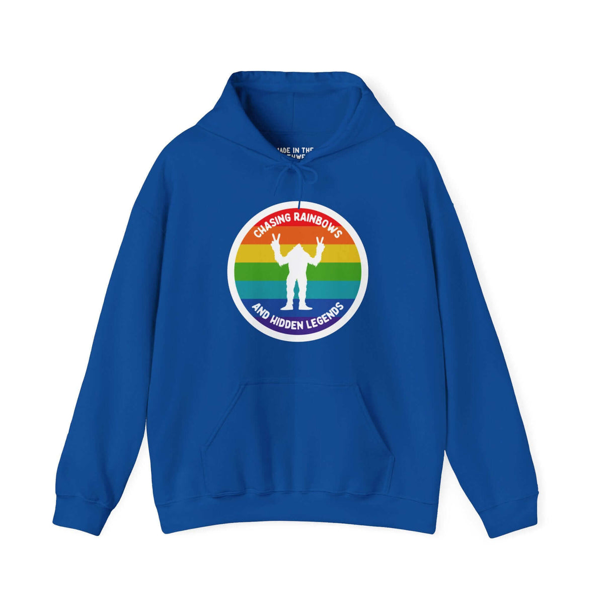 Blue Sasquatch hoodie with rainbow circle design, text "Chasing Rainbows and Hidden Legends," celebrating PNW spirit.