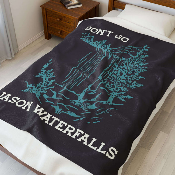 Don't Go Jason Waterfalls Lightweight Cozy Blanket displayed on a bed, showcasing its fun design and soft texture.