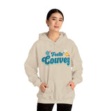 Woman wearing Feelin' Couvey Retro Hoodie with 70s style font and colorful aqua and pink flowers, celebrating Vancouver spirit.