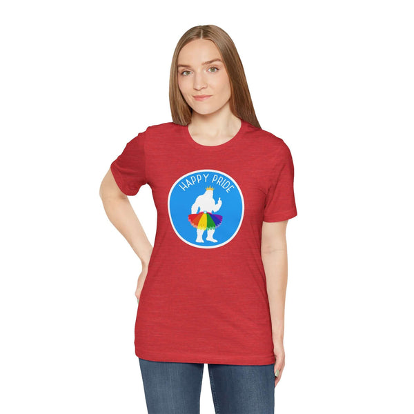Model wearing a red tee with 'Happy Pride' graphic featuring Bigfoot in a rainbow tutu, celebrating Pride spirit.