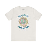 Premium soft tee featuring a peace flower design with 'Do No Harm, Take No Shit' slogan for a bold, uplifting style.