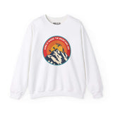 White sweatshirt with 'Home is Where the Mountains Are' design, featuring mountains, hiking, motocross, and Bigfoot in a colorful circle.