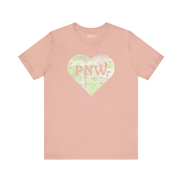 PNW Explorer's Heart Premium Soft Tee in pink with topo map design and 'PNW' logo, perfect for outdoor adventures.