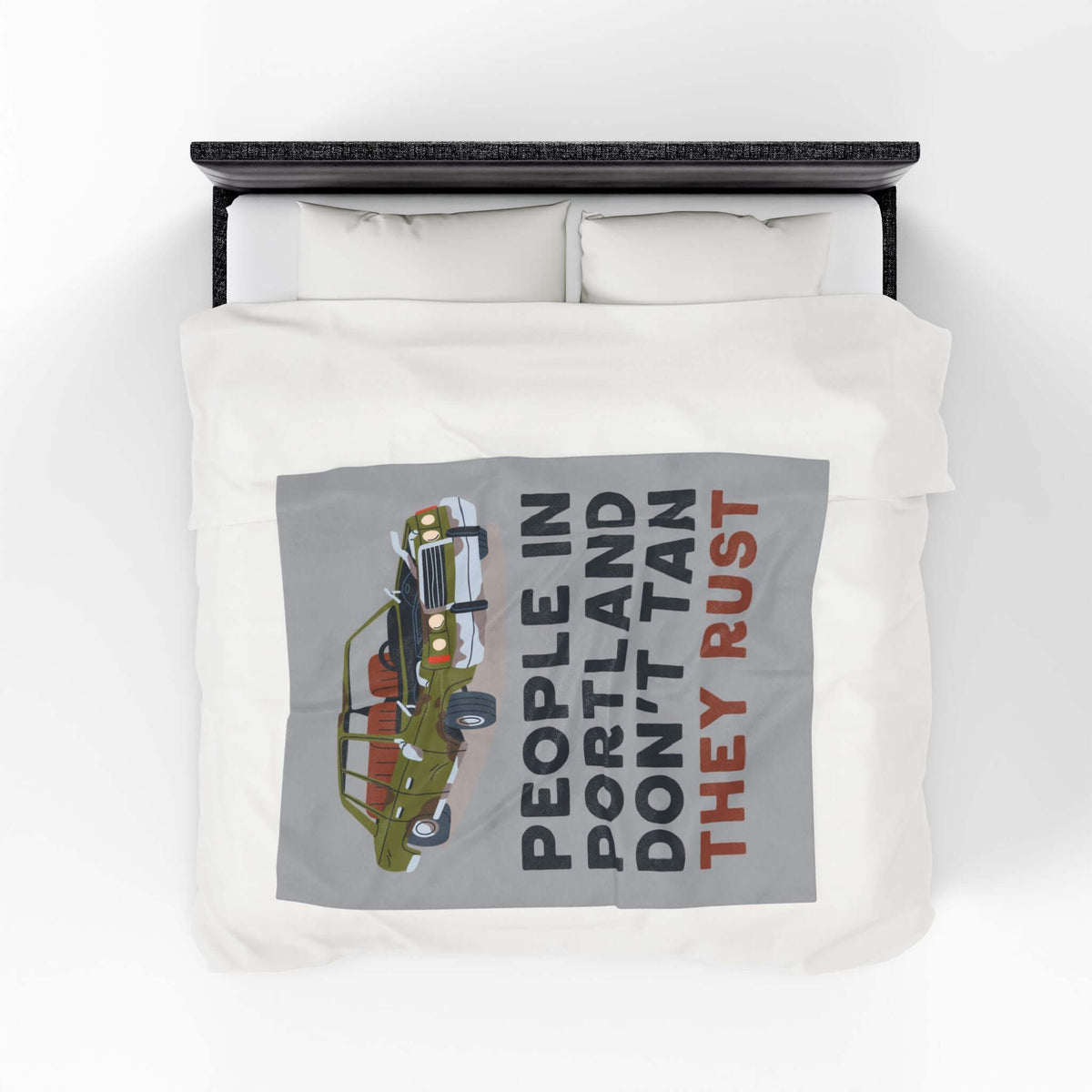 People in Portland Don't Tan They Rust Lightweight Cozy Blanket displayed on a bed with vintage car design.