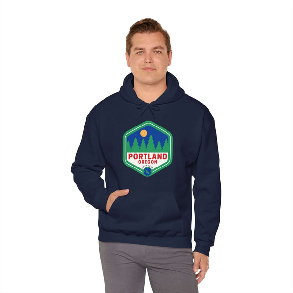 Man wearing Portland Best of the NW Retro hoodie with 90s-inspired badge featuring trees and city name, showcasing urban and natural beauty.