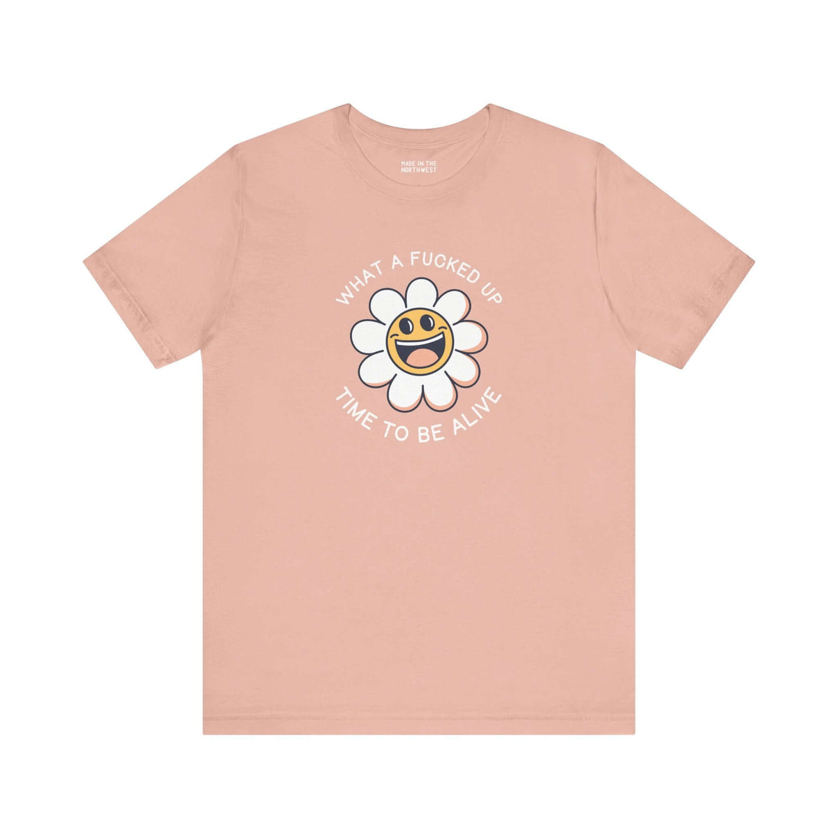 Pink premium tee with smiling daisy graphic and text "What a F*cked Up Time to Be Alive" for humorous expression.