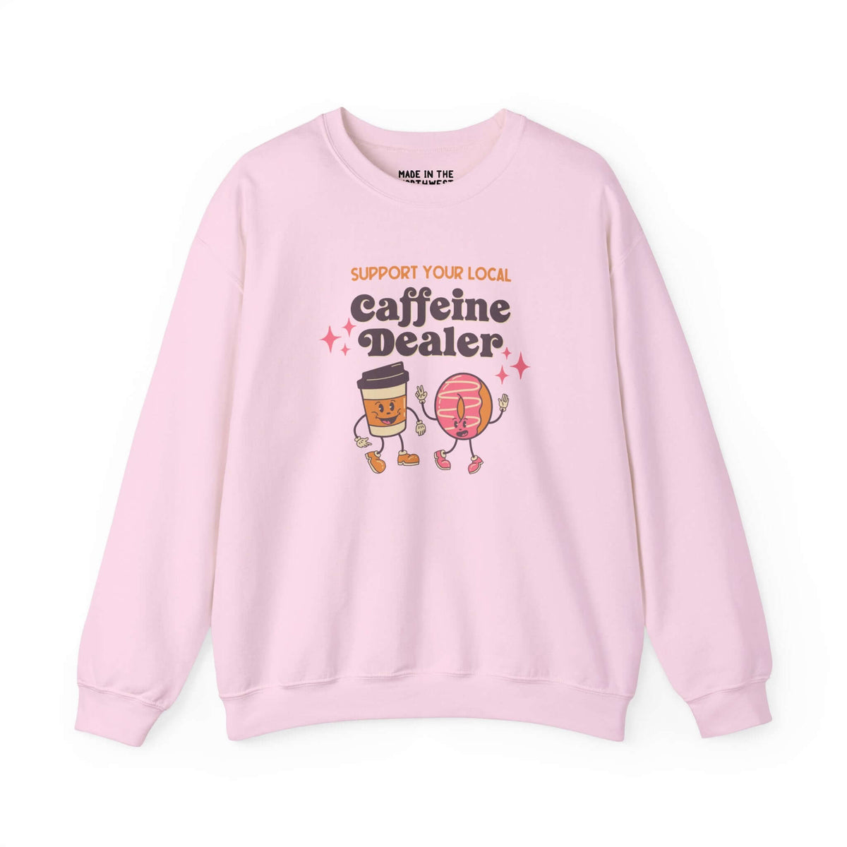 Pink sweatshirt with playful 'Support Your Local Caffeine Dealer' graphic featuring coffee cup and donut.