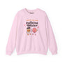 Pink sweatshirt with playful 'Support Your Local Caffeine Dealer' graphic featuring coffee cup and donut.