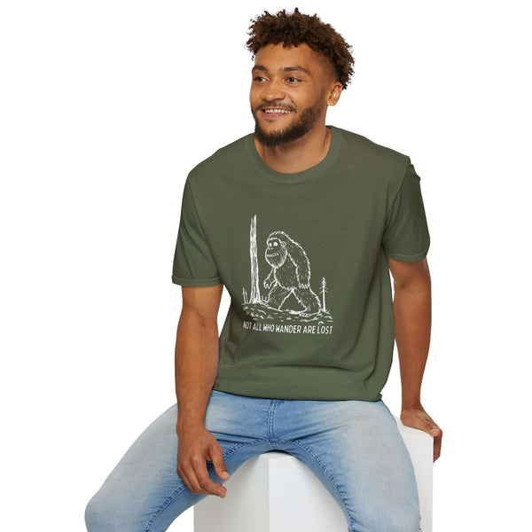 Not All Who Wander Are Lost Bigfoot Softstyle T-Shirt worn by man, featuring Sasquatch design for outdoor enthusiasts.
