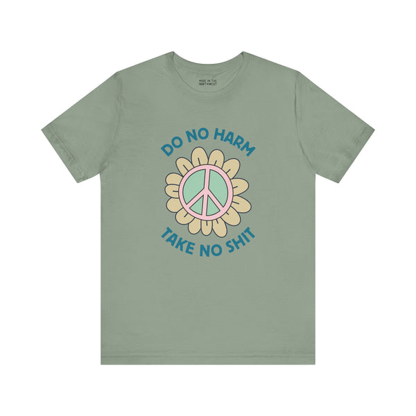 Do No Harm Take No Sh!t premium soft tee with peace flower design on a muted green shirt.