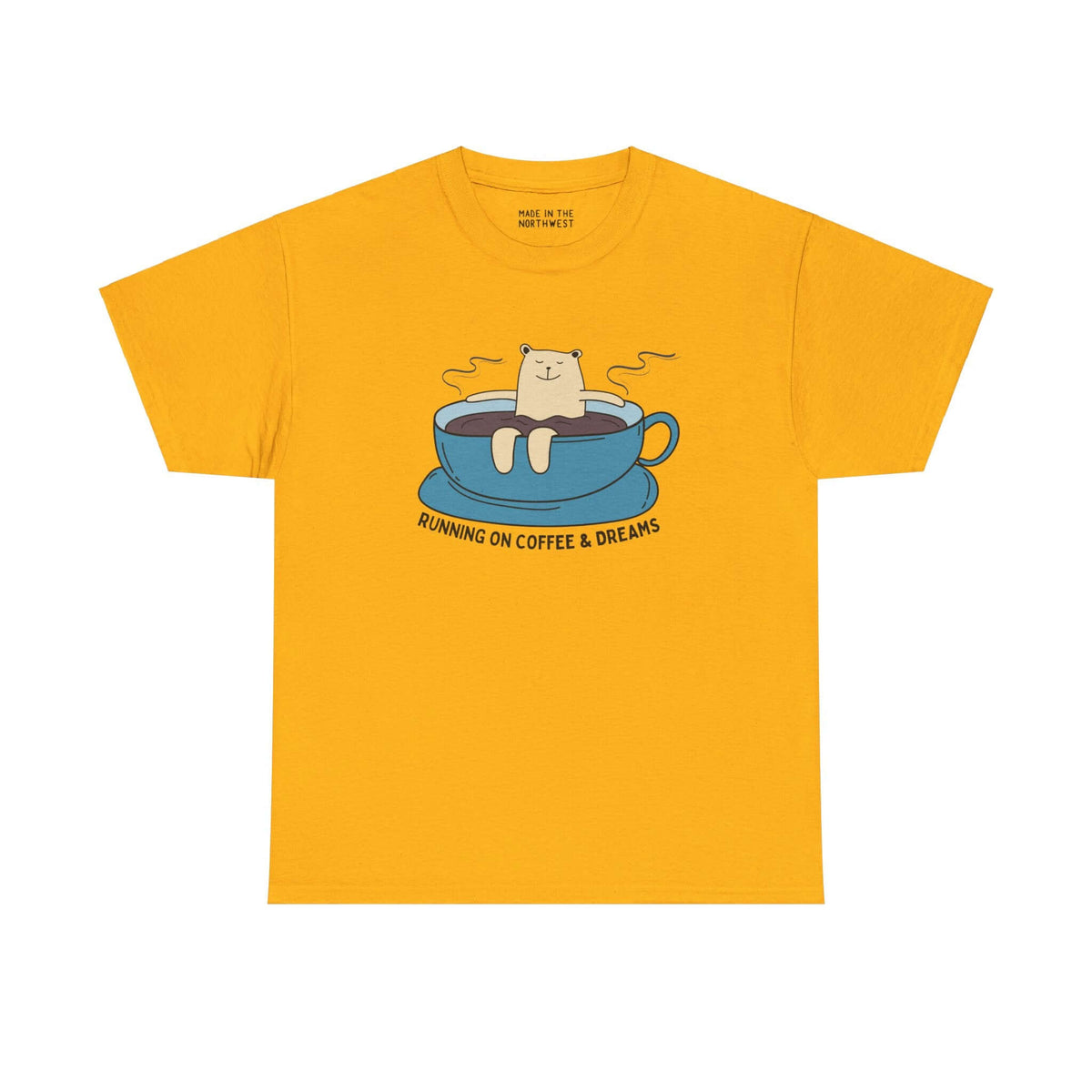 Yellow tee with bear lounging in coffee cup, text "Running on Coffee and Dreams," perfect for coffee lovers and PNW adventurers.