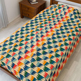 Apres Evergreen in the PNW Retro Lightweight Cozy Blanket featuring vibrant retro ski colors and pine tree design.