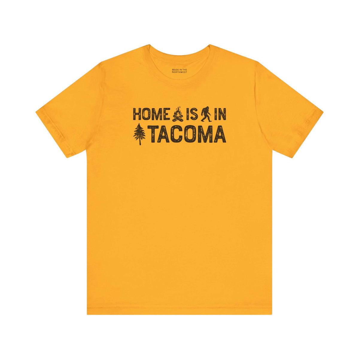 Home is in Tacoma tee featuring campfire, Bigfoot, and tree graphics on a yellow shirt.