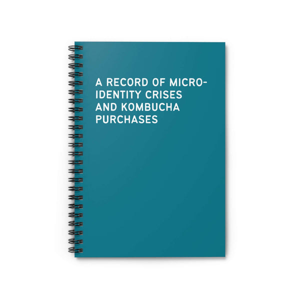 Teal spiral notebook titled 'A Record of Micro-Identity Crises and Kombucha Purchases' for personal reflection.