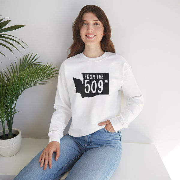 Model wearing a white 'From the 509' Spokane sweatshirt with Washington state silhouette and star, representing local pride.