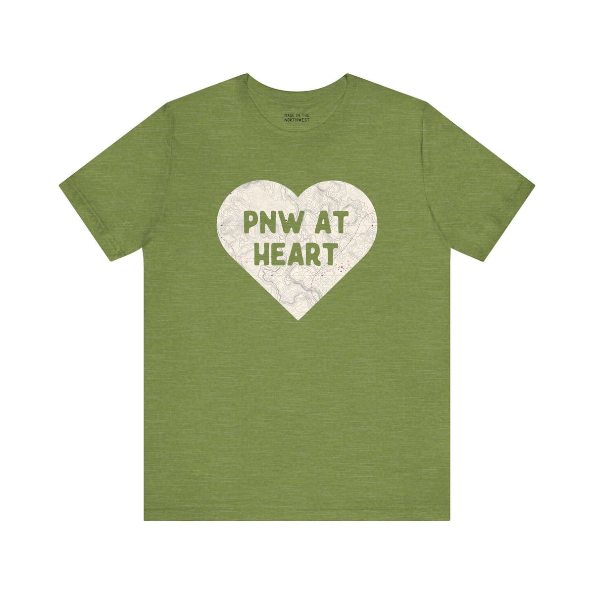 Green t-shirt featuring a heart-shaped map with "PNW at Heart" text, representing Pacific Northwest pride and love for the region.