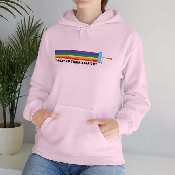 Model wearing a pink hoodie with the text 'Too Gay To Think Straight' and a paint roller graphic.