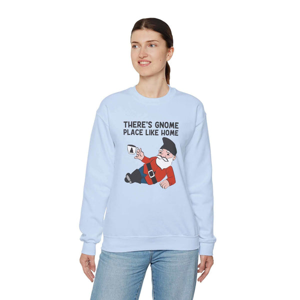 Woman wearing a light blue sweatshirt featuring a playful gnome graphic and the phrase 'There's Gnome Place Like Home.'