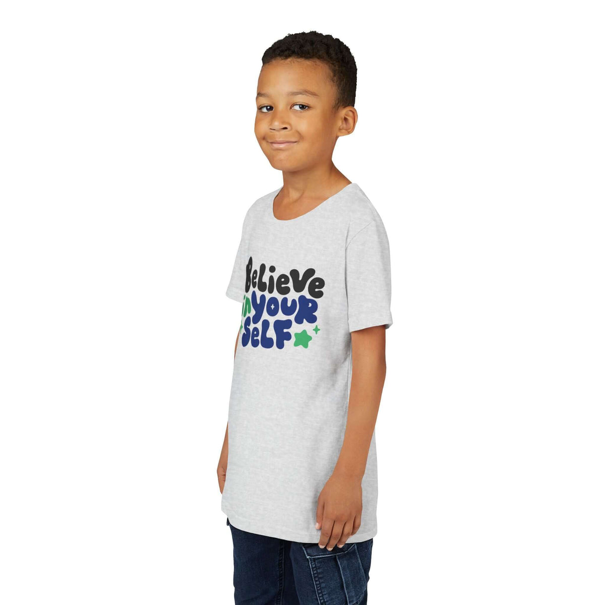 Kid smiling while wearing a Believe in Yourself Kids T Shirt with colorful text.