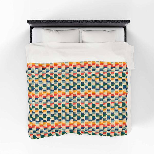 Apres Evergreen in the PNW Retro Lightweight Cozy Blanket featuring retro ski colors and a unique pattern.
